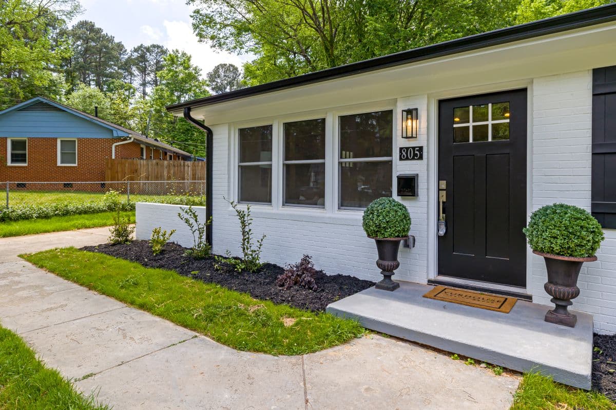 A single-story home with a landscaped entrance and front porch